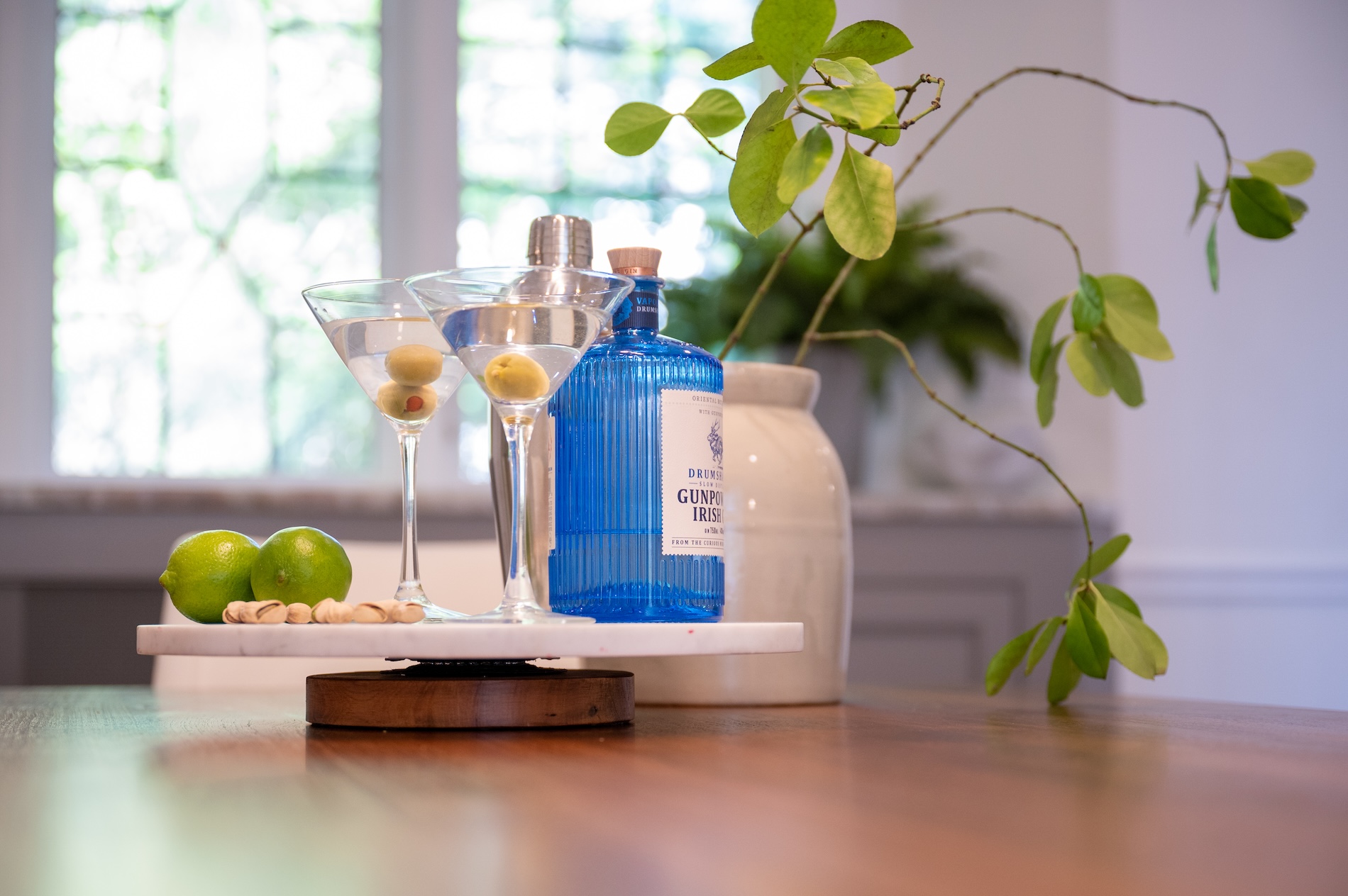 Martini Glasses With Olives And Limes On Marble Display