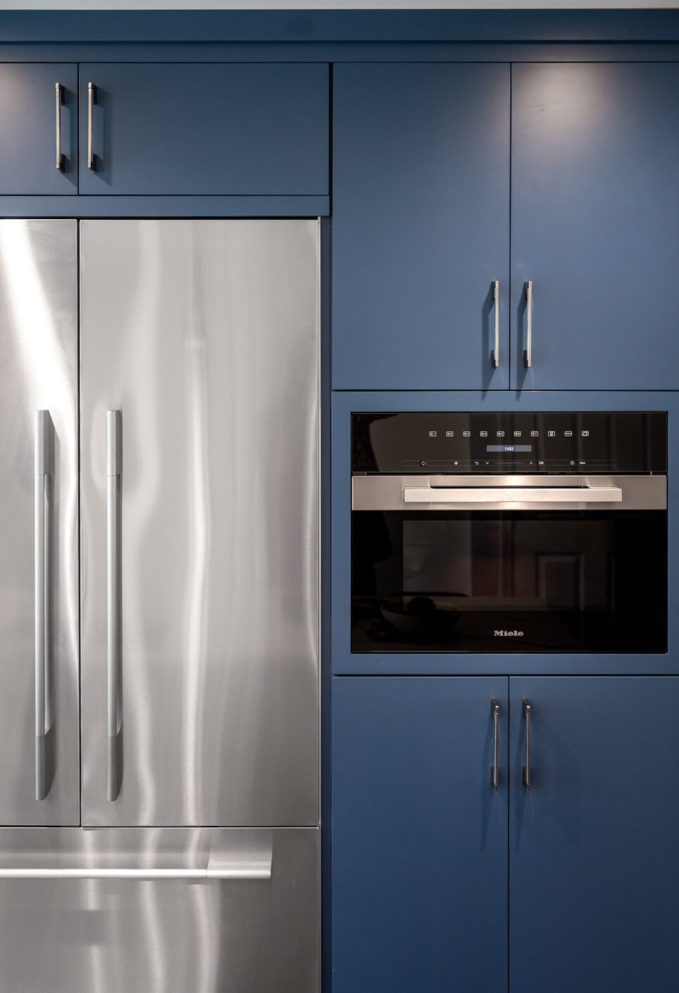 Stainless Fridge And Blue Cabinets
