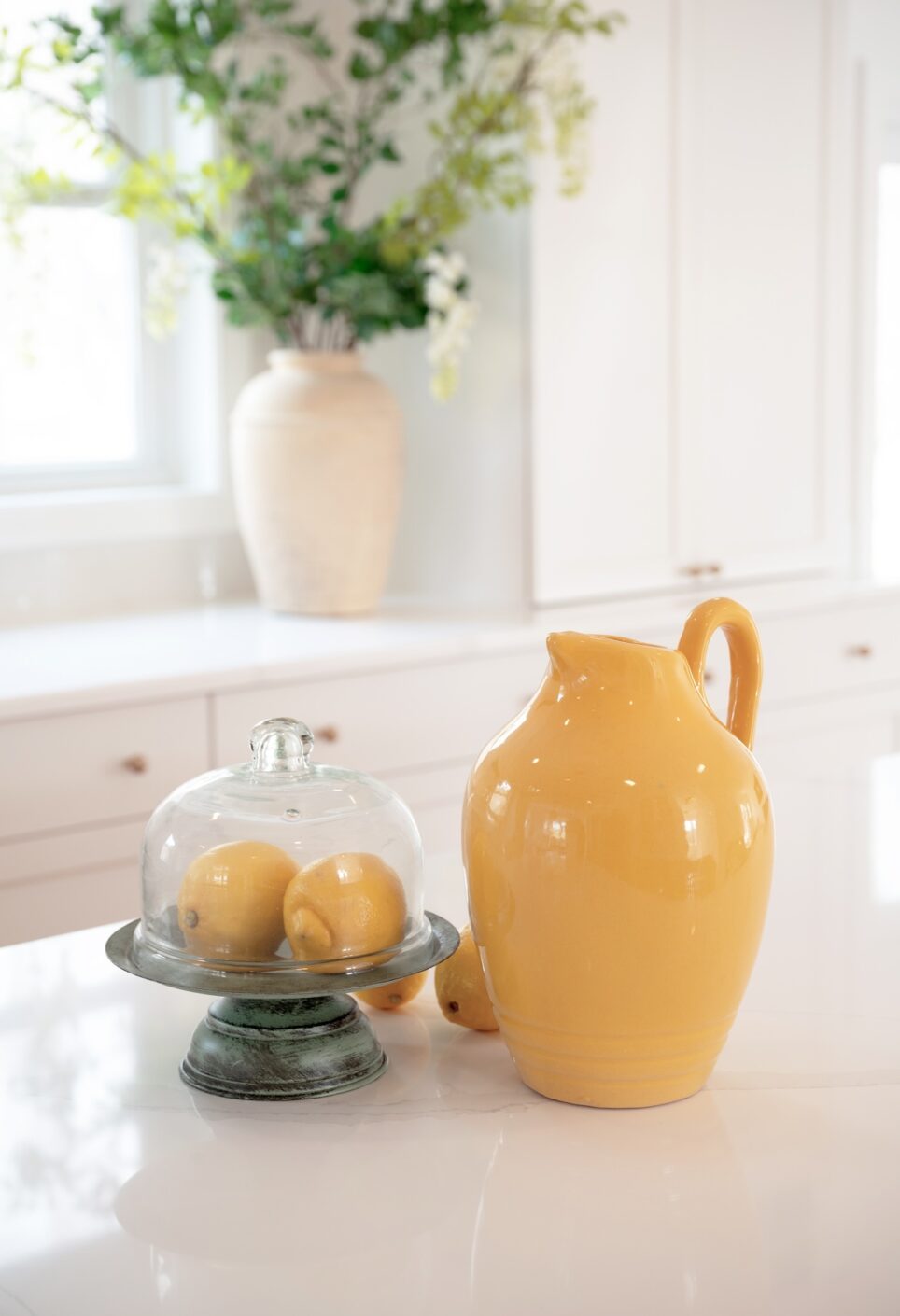 Yellow Pitcher Lemons In Glass Display