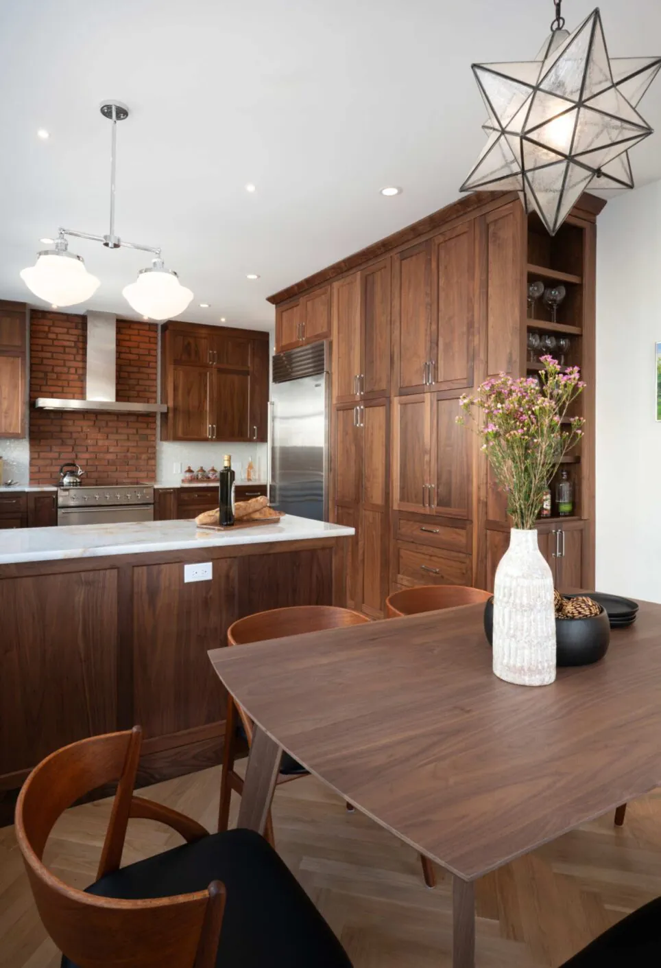 Walnut Kitchen Cabinetry With Dark Wooden Kitchen Table And Chairs